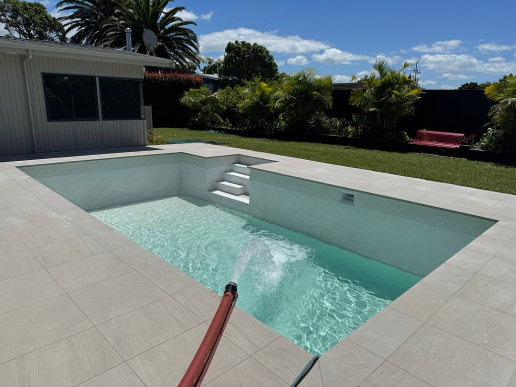 Bulk swimming pool water delivery truck filling a commercial pool in Auckland
